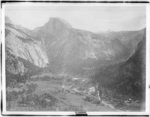 A black and white panoramic photograph of Yosemite Valley and the Half Dome in Yosemite National Park.