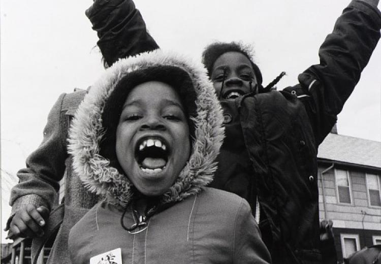 Children wearing winter coats and laughing in Buffalo, NY (1979). Photograph by David Seaman.