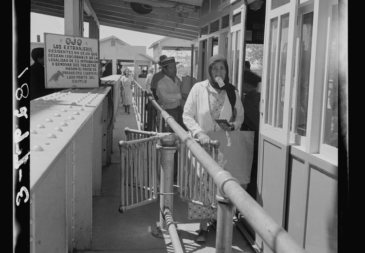 people lining up at an immigration station